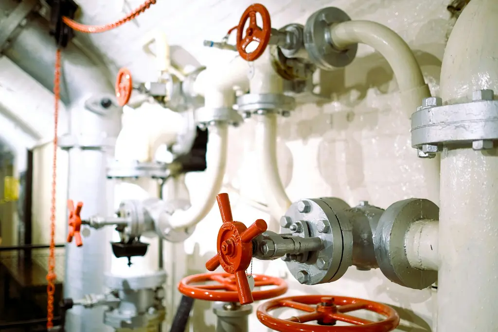 Pump room with pipes and red valves